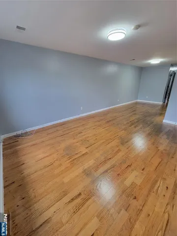 an empty room with wooden floor