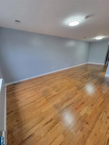 an empty room with wooden floor