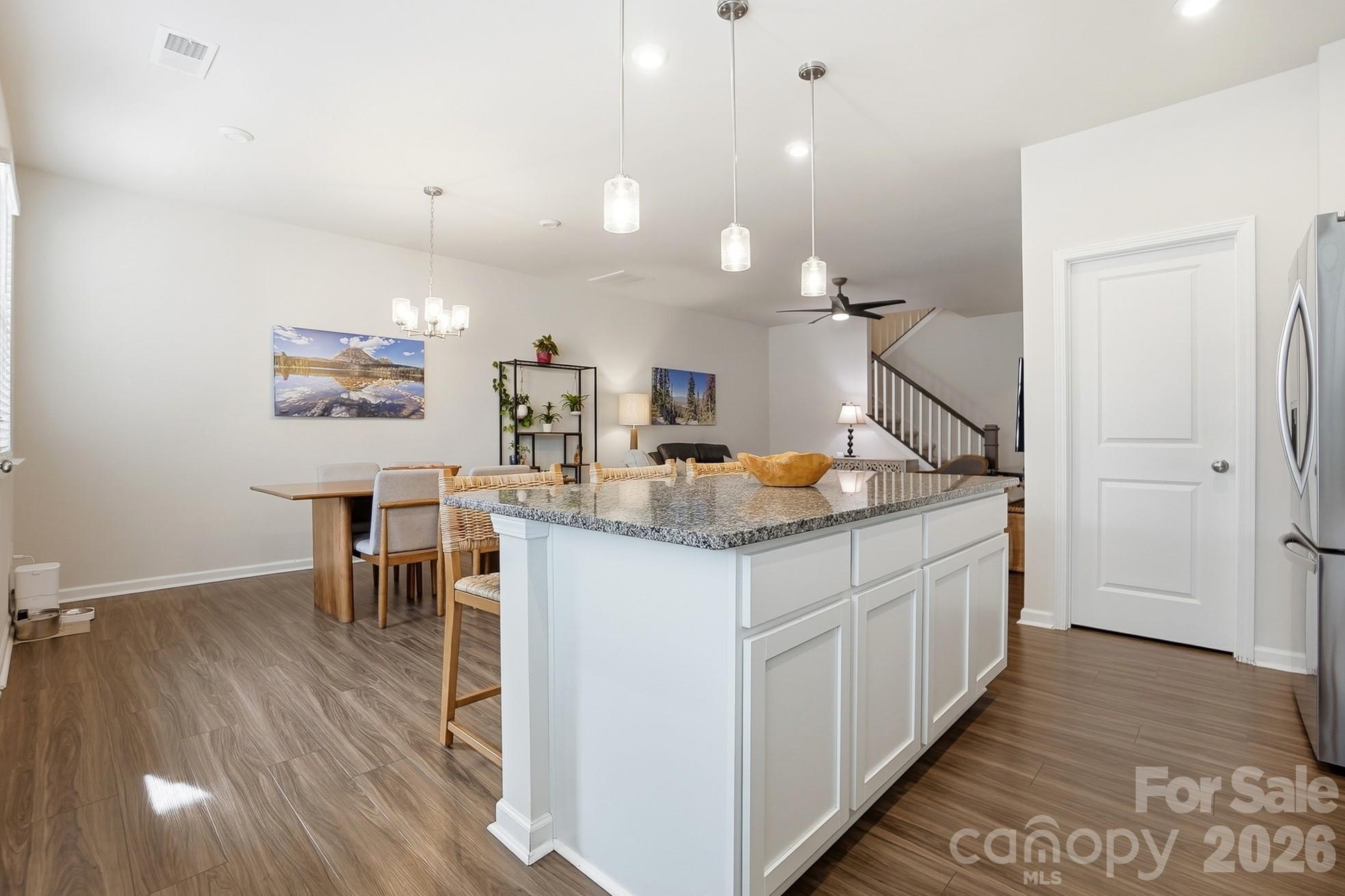 6351 Lopez Court Kannapolis, NC 28081 - Photo 13 of 48 a kitchen with stainless steel appliances granite countertop a stove a sink a dining table and chairs