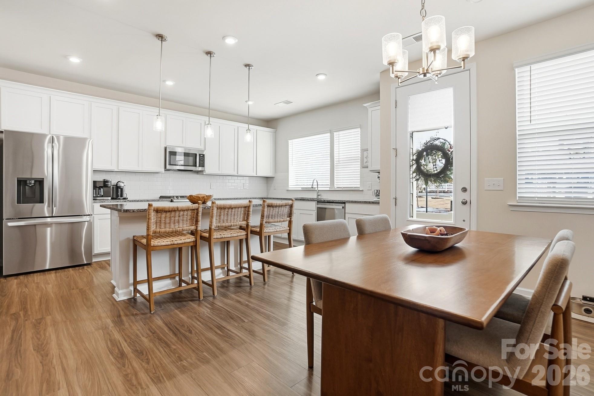 6351 Lopez Court Kannapolis, NC 28081 - Photo 15 of 48 a kitchen with kitchen island a stove a table and chairs in it