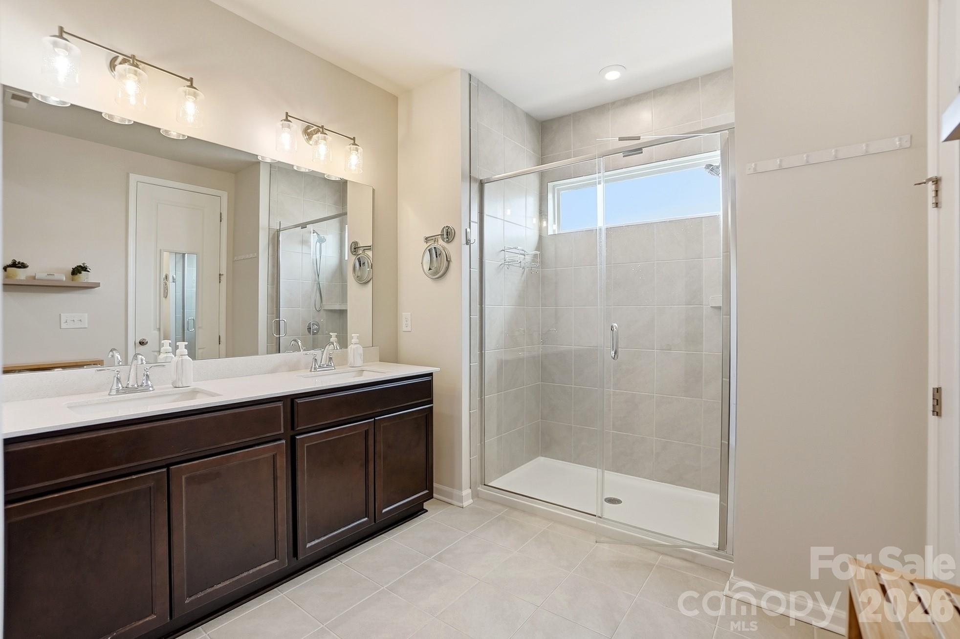 6351 Lopez Court Kannapolis, NC 28081 - Photo 26 of 48 a bathroom with a shower sink and mirror