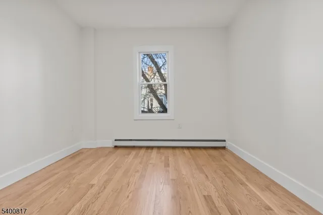 a view of room with window and wooden floor