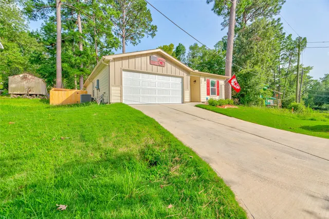 a view of a house with yard and a garden