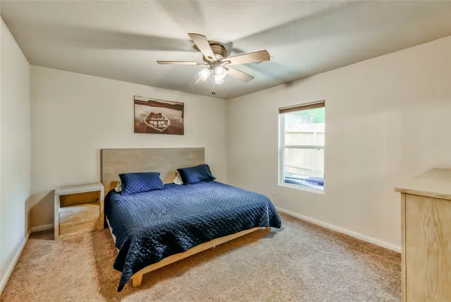 a bedroom with a bed and window