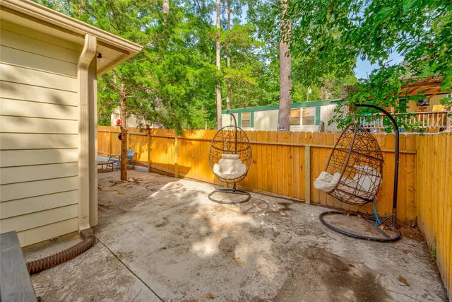 a view of a porch with a floor to ceiling window and tree