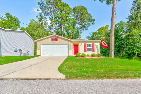 a view of a with a big yard and palm trees