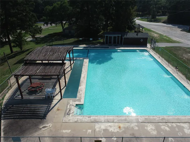 a view of a patio with chairs and potted plants