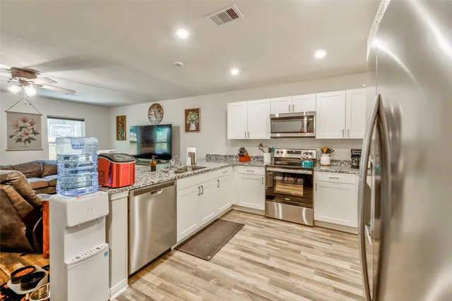 a kitchen that has a lot of cabinets and refrigerator