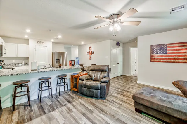 a living room with furniture and wooden floor