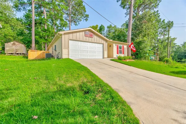 a view of a garage with a small yard