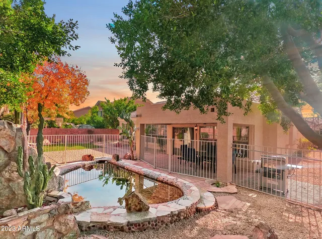 a view of a house with swimming pool in front of it