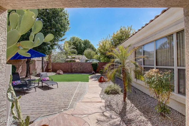 a dining room with furniture water view and a floor to ceiling window