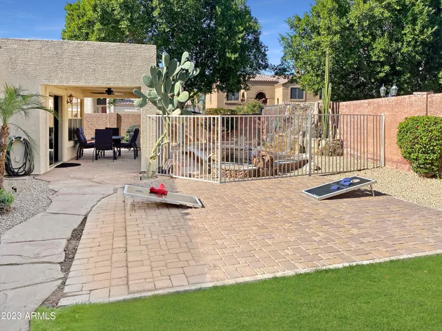 a view of a chair and table in backyard