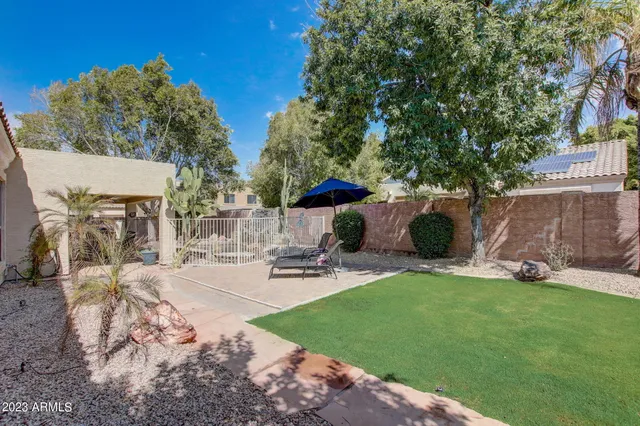 a view of a table and chairs in patio with a yard