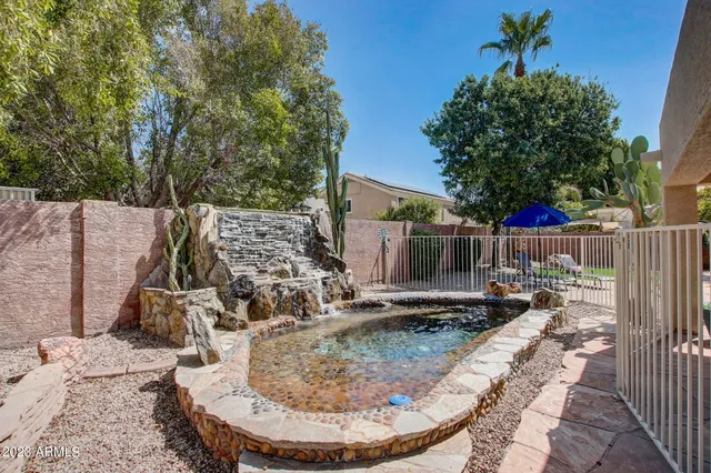 a white house covered with tall trees