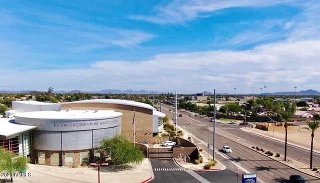 a view of park with swings and slides