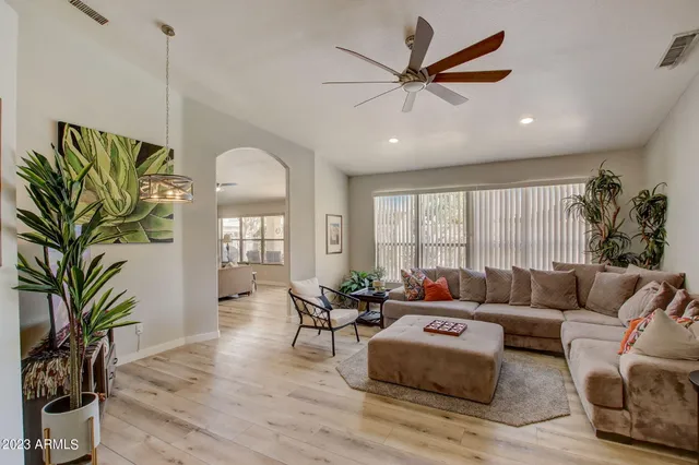a living room with furniture and a large window