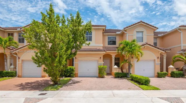 a front view of a house with a yard and garage
