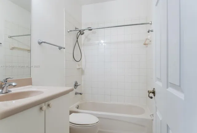a bathroom with a bathtub shower sink and toilet