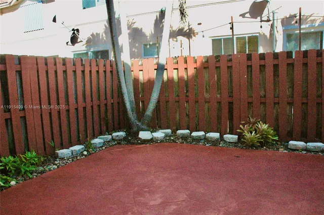 a view of a street with a wooden fence