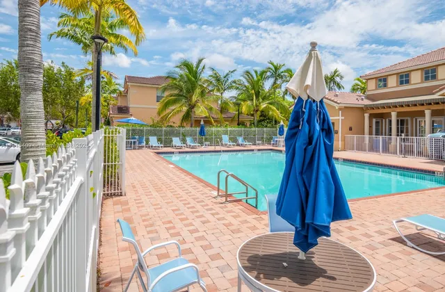 a view of swimming pool with a garden and trees