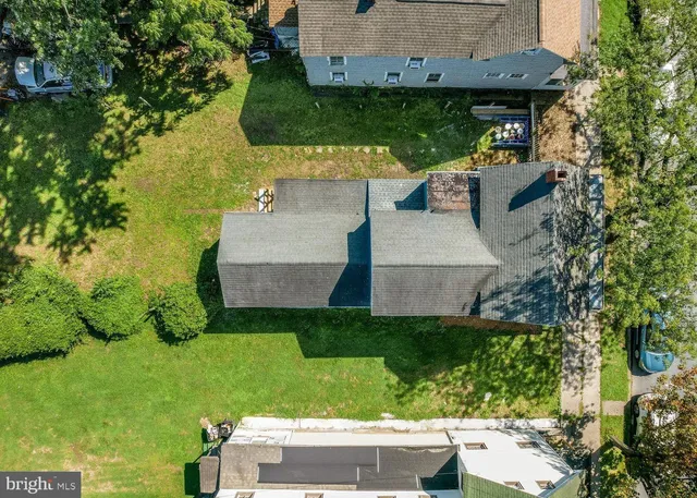an aerial view of a house with a yard