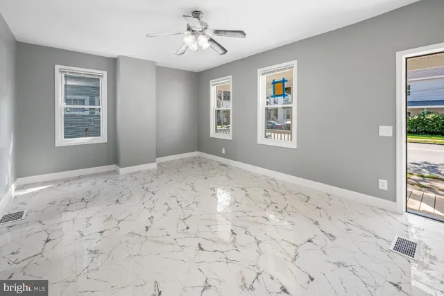 a view of a bedroom with wooden floor and windows
