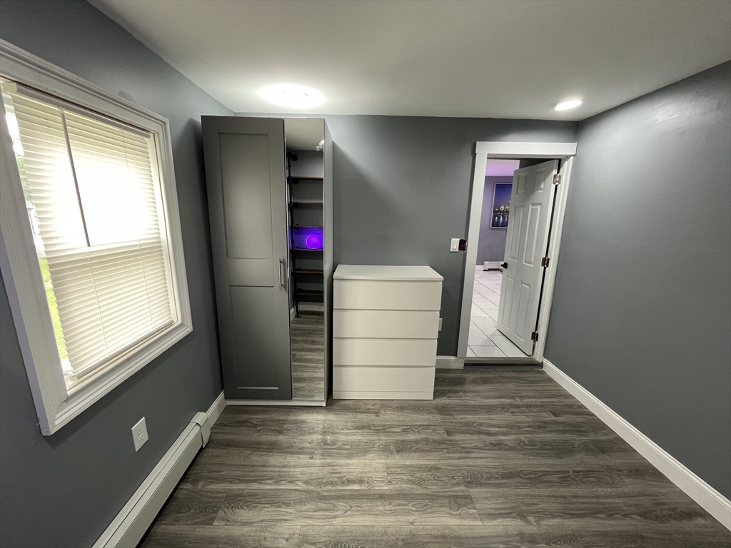 27 Overlook Road Holbrook, MA 02343 - Photo 14 of 25 an empty room with wooden floor and windows