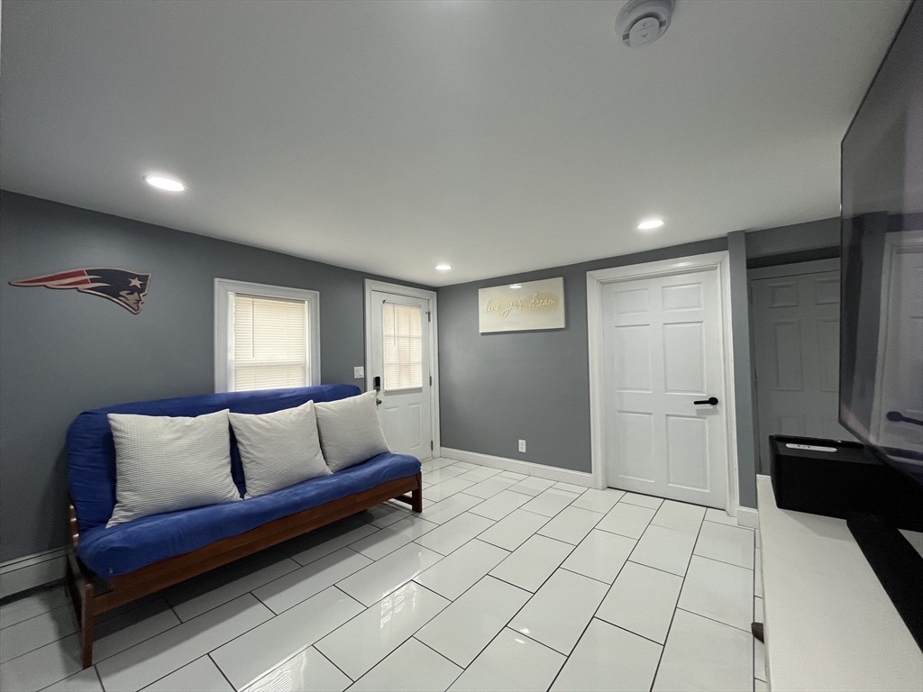 27 Overlook Road Holbrook, MA 02343 - Photo 5 of 25 a spacious bedroom with a bed and a couch