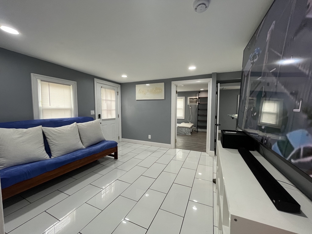 27 Overlook Road Holbrook, MA 02343 - Photo 9 of 25 a large living room with a couch and a view of kitchen