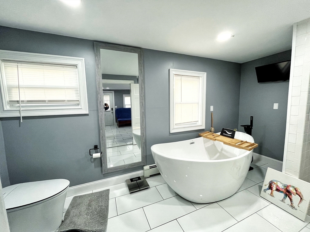 27 Overlook Road Holbrook, MA 02343 - Photo 10 of 25 a spacious bathroom with a bathtub and toilet