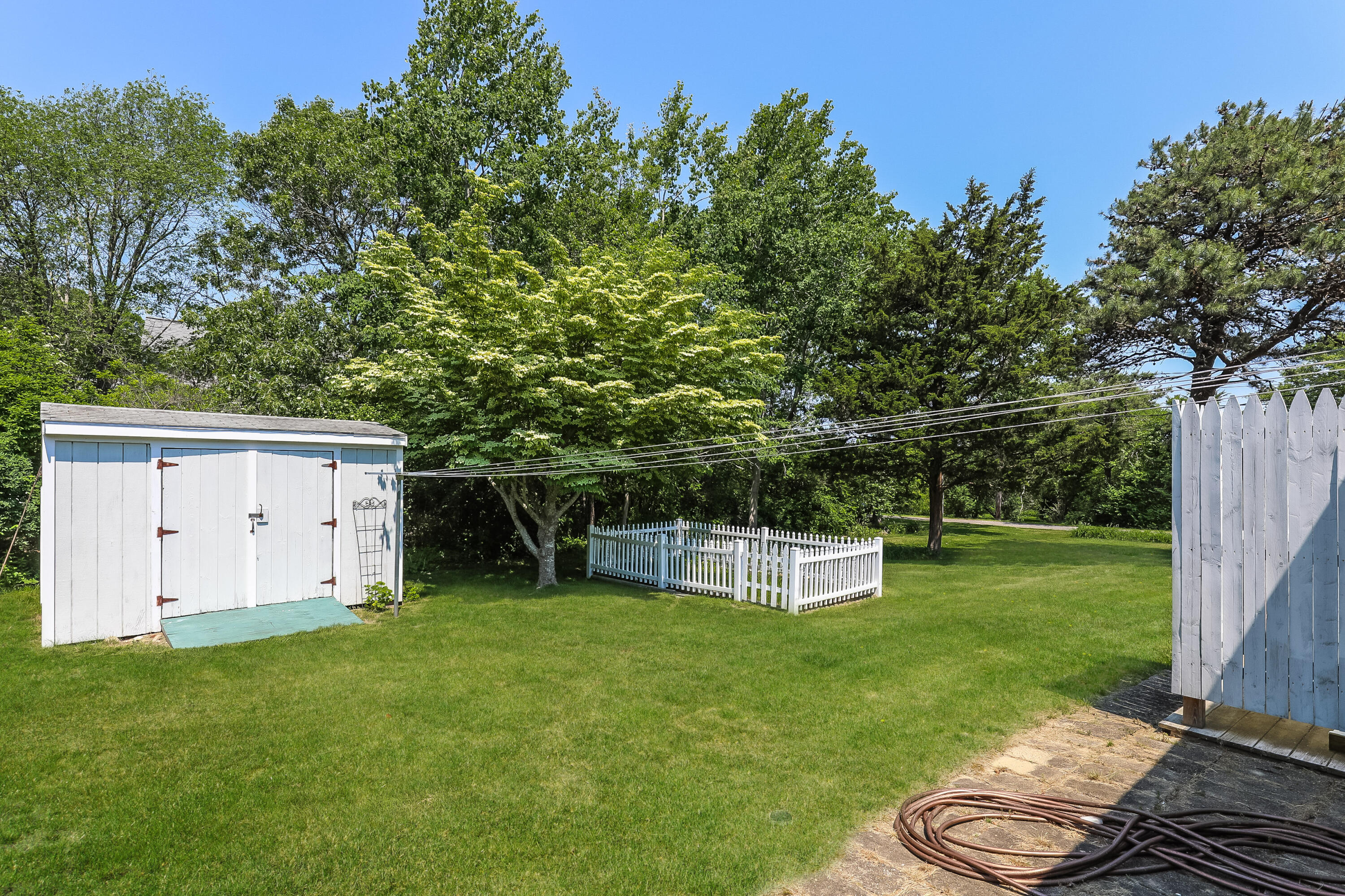 14 Captain Kidd Road East Sandwich, MA 02537 - Photo 19 of 29 a view of a backyard with a garden and fire pit