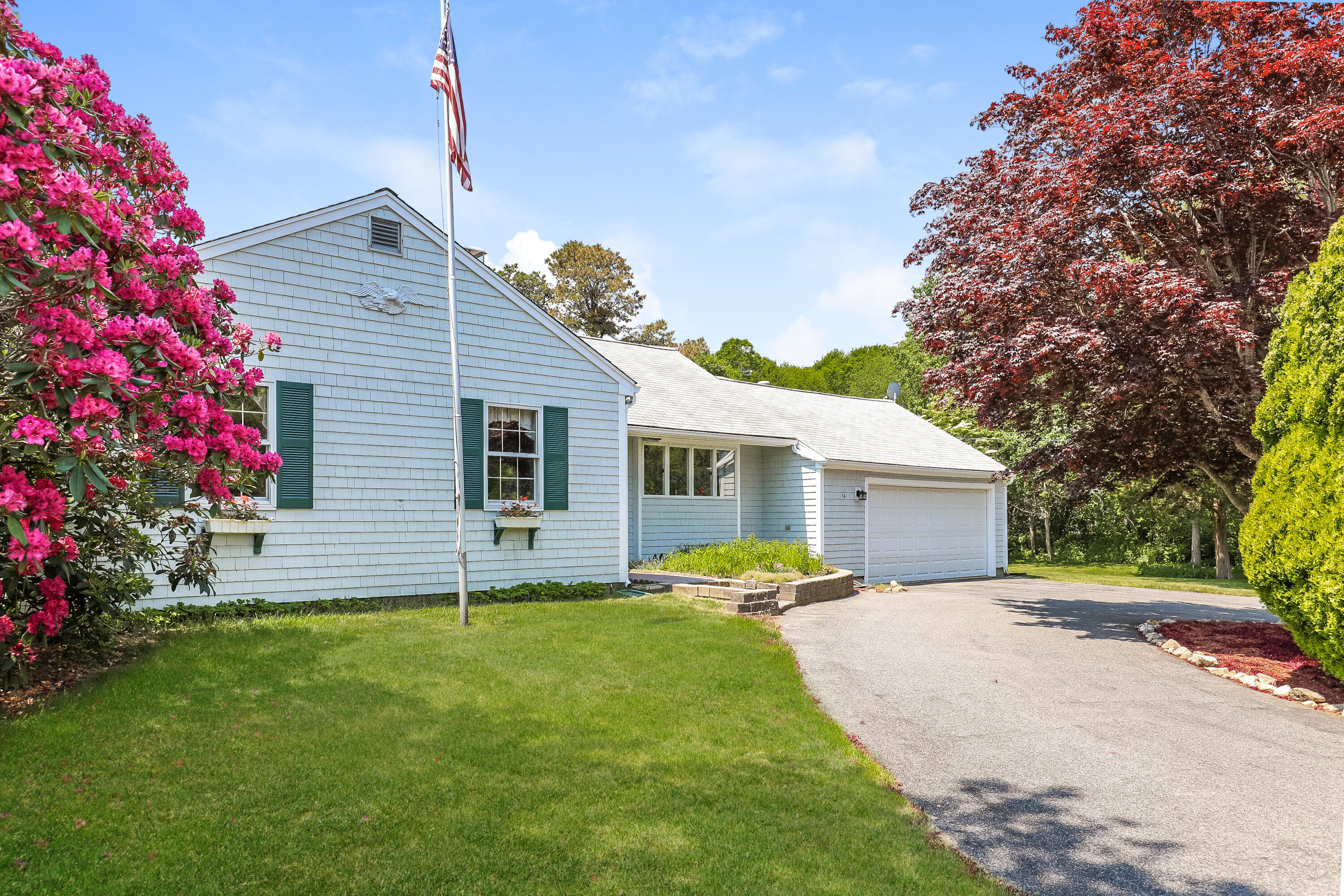 14 Captain Kidd Road East Sandwich, MA 02537 - Photo 2 of 29 a front view of house with yard and trees in the background