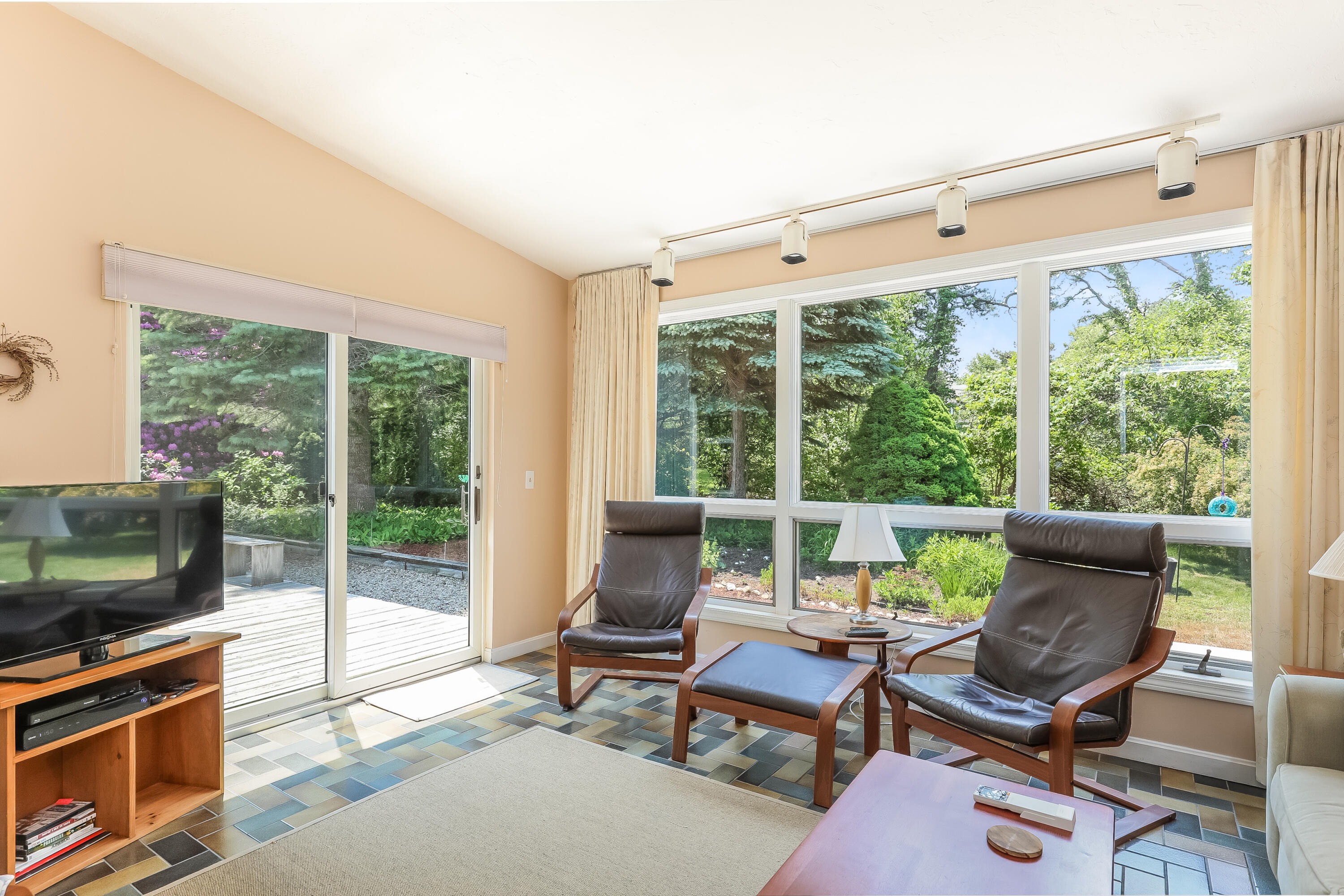 14 Captain Kidd Road East Sandwich, MA 02537 - Photo 9 of 29 a living room with furniture a flat screen tv and floor to ceiling window