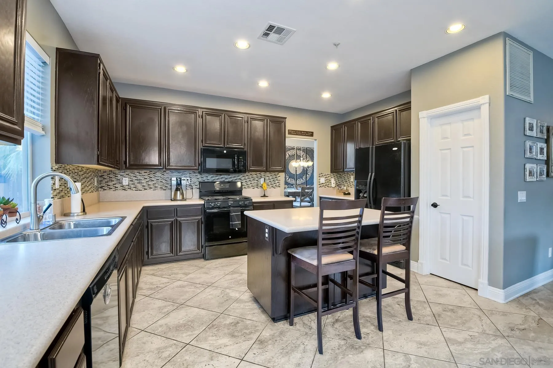 10340 Hitching Post Way Santee, CA 92071 - Photo 15 of 50 a kitchen with kitchen island granite countertop a sink counter top space appliances and cabinets