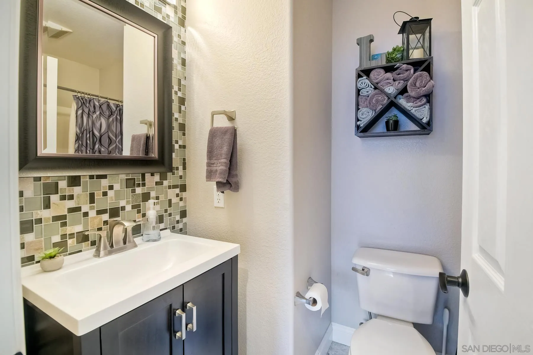 10340 Hitching Post Way Santee, CA 92071 - Photo 23 of 50 a bathroom with a toilet sink and mirror