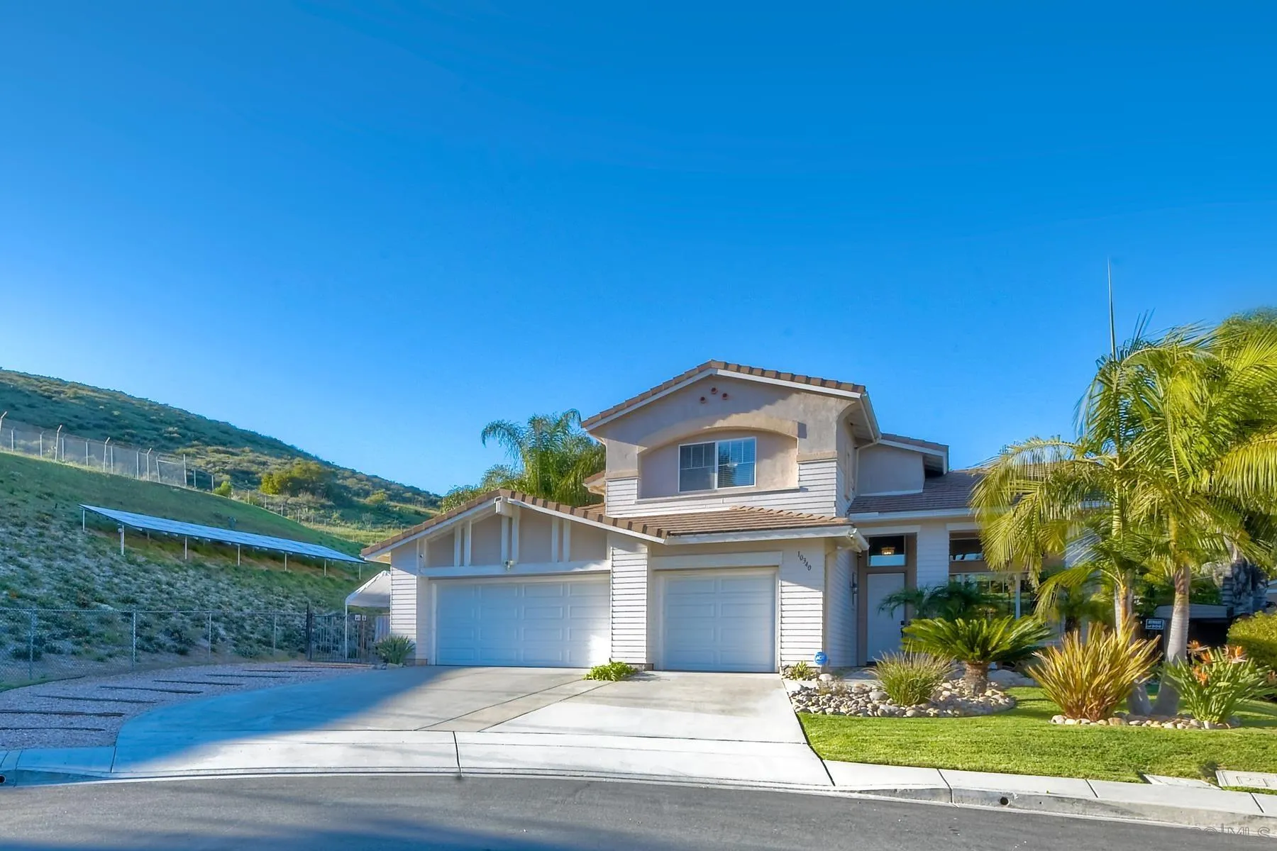 10340 Hitching Post Way Santee, CA 92071 - Photo 5 of 50 a front view of a house with a garden
