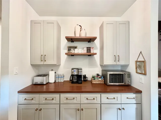 a kitchen with stainless steel appliances a stove a sink and cabinets