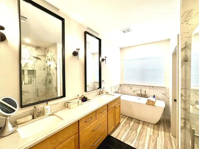 a bathroom with a double vanity sink mirror and double