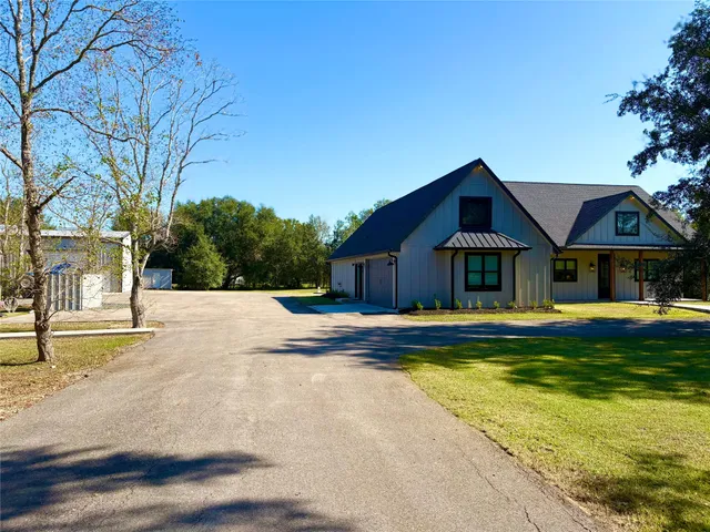 a front view of house with yard and green space