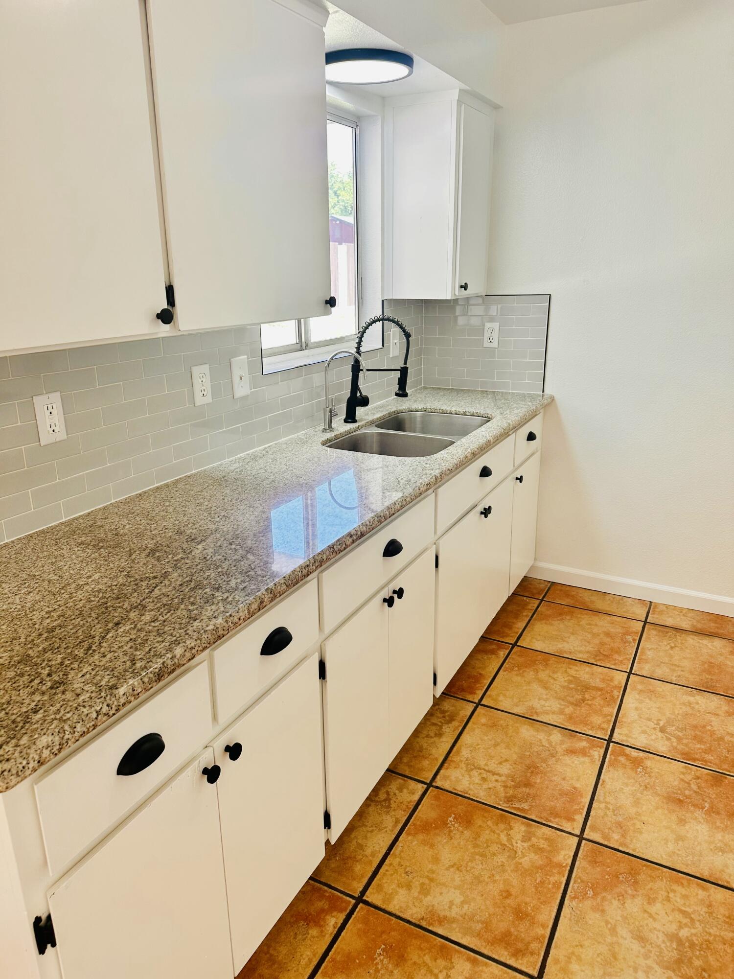 30880 Farr Road Visalia, CA 93291 - Photo 8 of 27 a kitchen with granite countertop white cabinets and a sink
