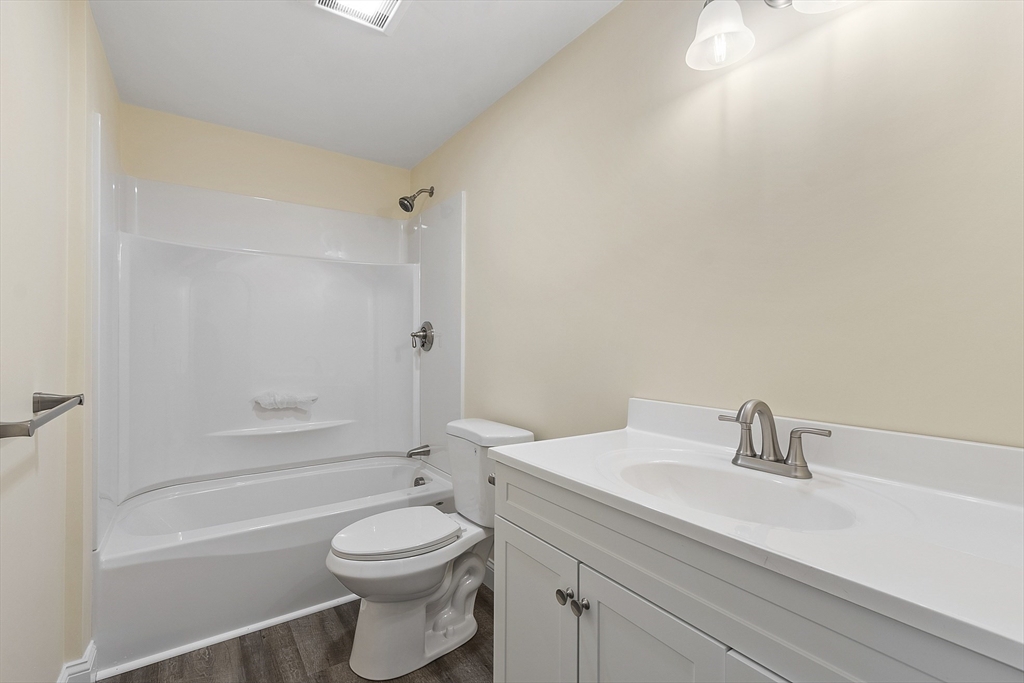 20 Townsend Street, Unit 2 Pepperell, MA 01463 - Photo 16 of 23 a bathroom with a sink a toilet and shower