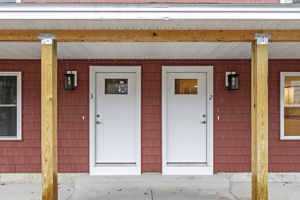 20 Townsend Street, Unit 2 Pepperell, MA 01463 - Photo 22 of 23 a front view of a building with a outdoor space