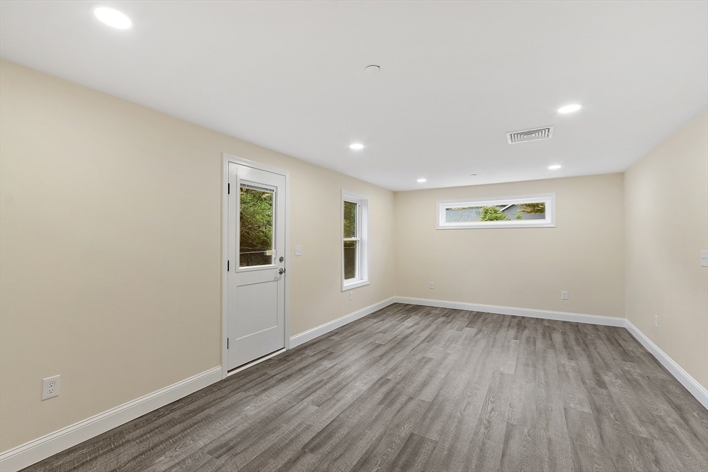 20 Townsend Street, Unit 2 Pepperell, MA 01463 - Photo 6 of 23 wooden floor in an empty room with a window