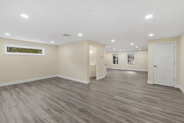 an empty room with wooden floor