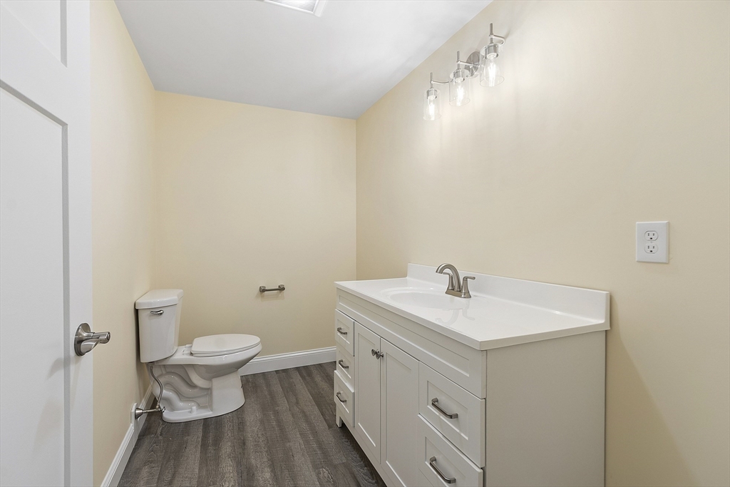 20 Townsend Street, Unit 2 Pepperell, MA 01463 - Photo 9 of 23 a bathroom with a sink toilet and a mirror