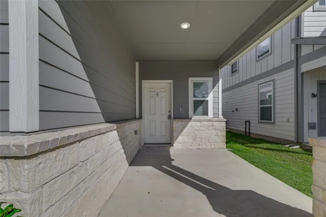 a view of an empty room with a window and fireplace