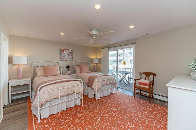 a spacious bedroom with two beds and a chair