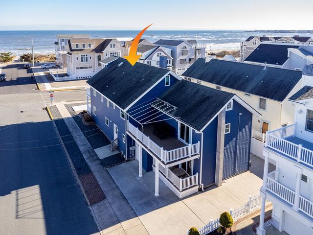 a roof deck with couches and wooden floor