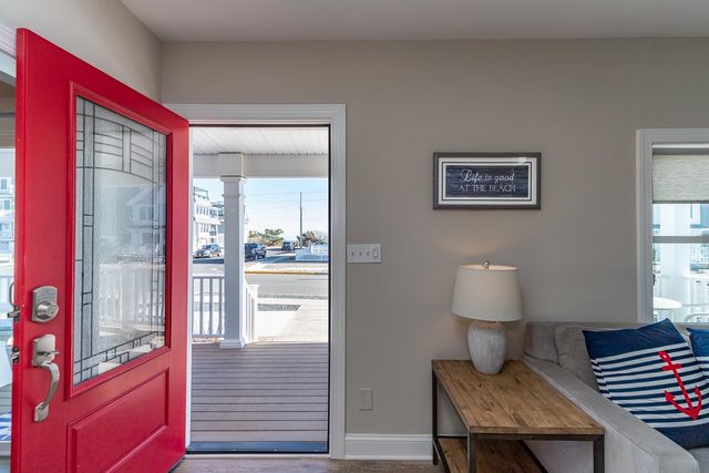 a view of a hallway with wooden floor and a living room